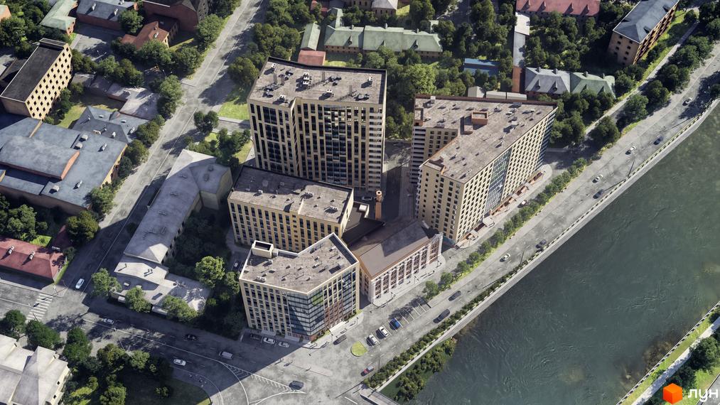 Житловий комплекс IT-Парк Manufactura складається з високих будівель світлого кольору. Він розташований біля річки, оточений дорогами та деревами.