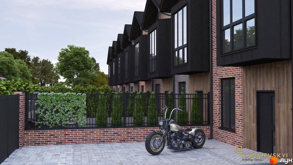 Таунхауси V8 townhouse з чорним фасадом та цегляними вставками. Прибудинкова територія з парканом та мотоциклом.