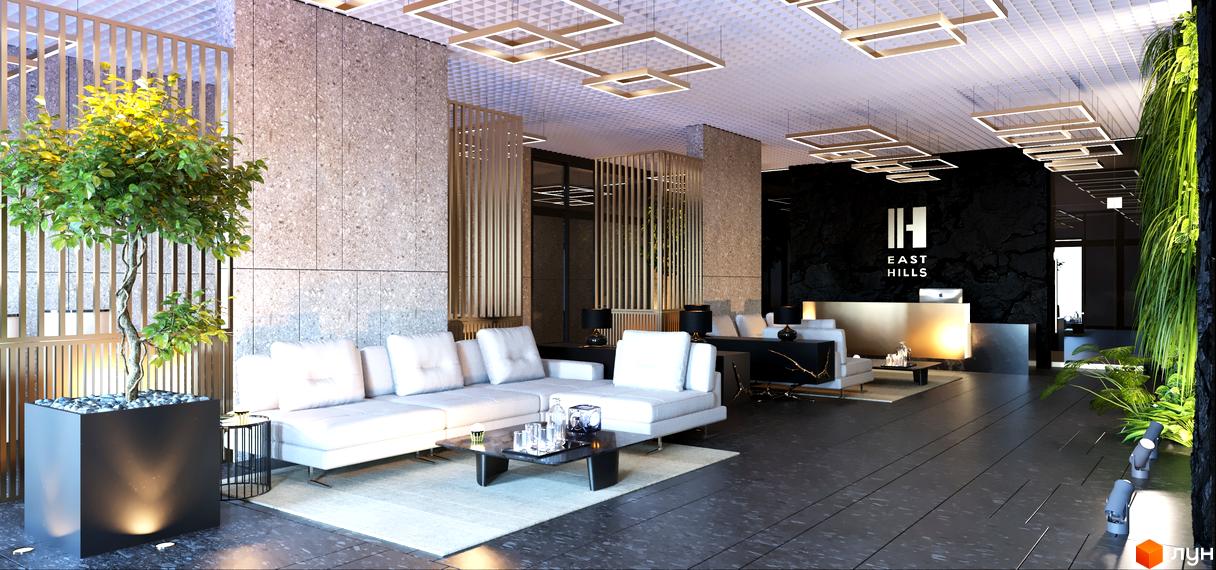 Сучасний інтер'єр лобі житлового комплексу East Hills з білими диванами, кавовим столиком та декоративним деревом. Привабливий простір для відпочинку та зустрічей.