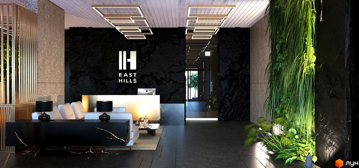 Лобі житлового комплексу High Hills з елегантною стійкою реєстрації, чорними акцентами та вертикальним озелененням.