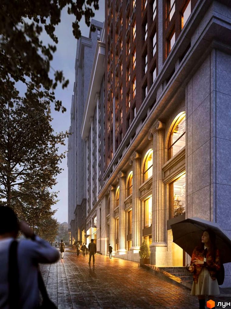 Зображення фасаду ЖК Stanford. Багатоповерхова будівля з великими вікнами та колонами вздовж тротуару, де ходять люди.