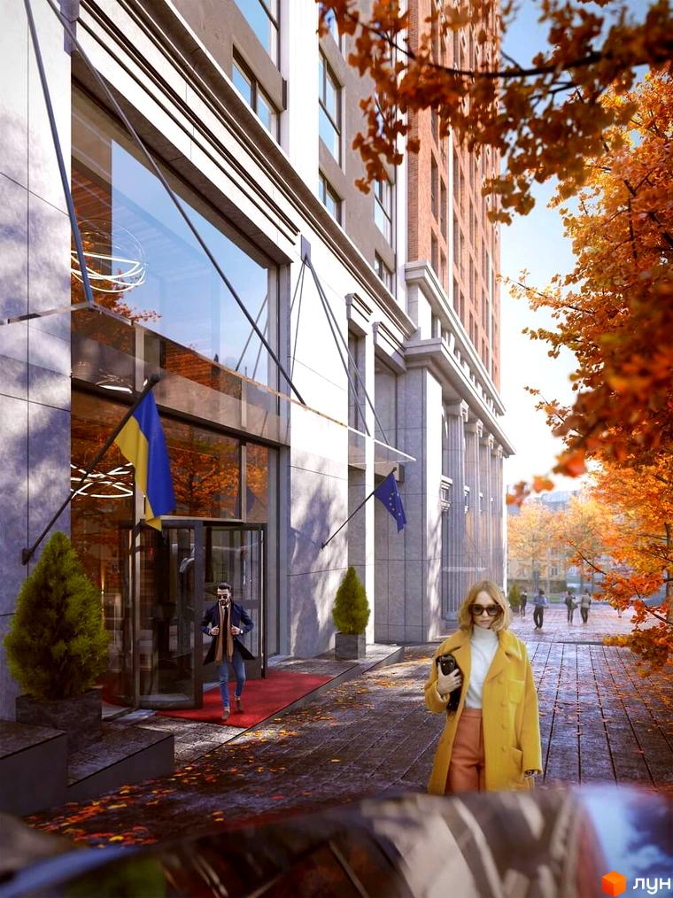 Житловий комплекс Stanford. Фасад будівлі з великими вікнами та колонами. На передньому плані люди, дерева з жовтим листям та бруківка.