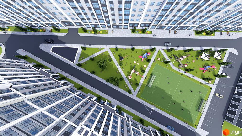 Вид зверху на багатоповерховий будинок ЖК Затишний з прибудинковою територією: дитячий майданчик, футбольне поле, парковка.