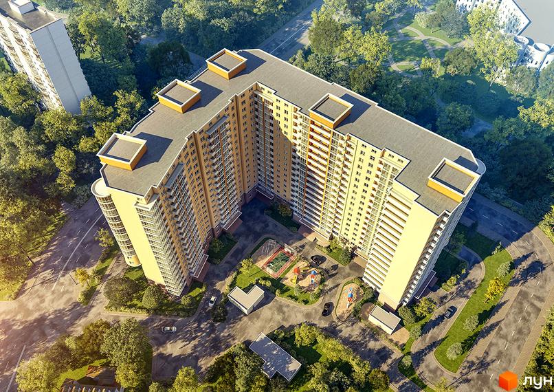 Житловий комплекс Новомостицький з висоти пташиного польоту, показує багатоповерховий будинок світлого кольору та внутрішній двір з дитячим майданчиком.