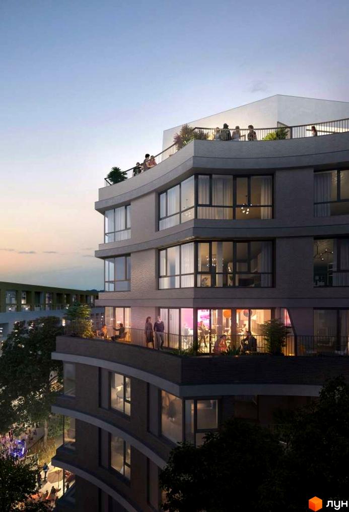 Багатоповерховий будинок Житлового району Rybalsky з вигнутими балконами. Вечірній вигляд, на терасах видно людей та освітлення.