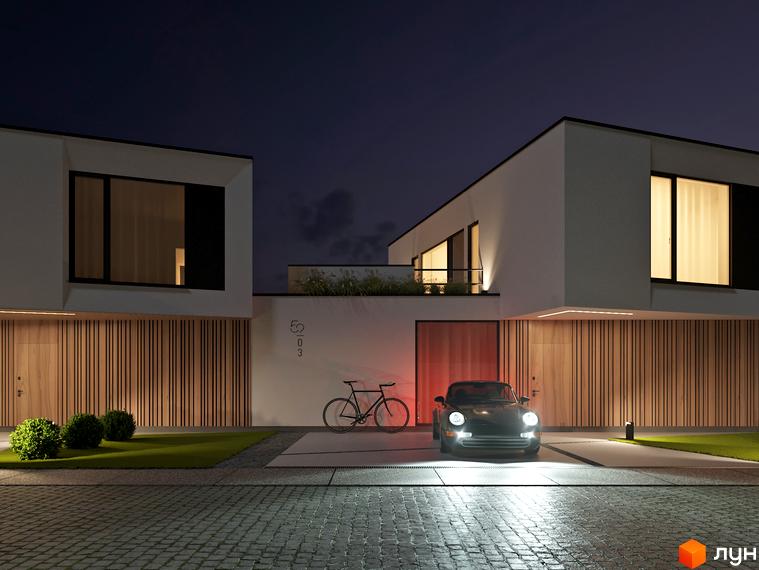 Котеджне містечко VIA 52 з сучасним дизайном та автомобілем біля входу. Територія комплексу освітлена вночі, створюючи затишну атмосферу.