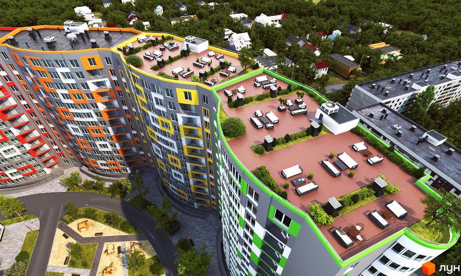 Житловий комплекс Вернісаж з терасами на даху. Яскравий фасад будівлі з поєднанням кольорів. На території є дитячий майданчик та зелені насадження.