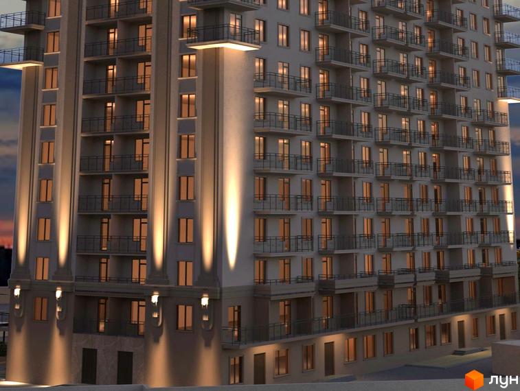 Фасад житлового комплексу Акрополь ввечері з вертикальною підсвіткою та рядами вікон і балконів.
