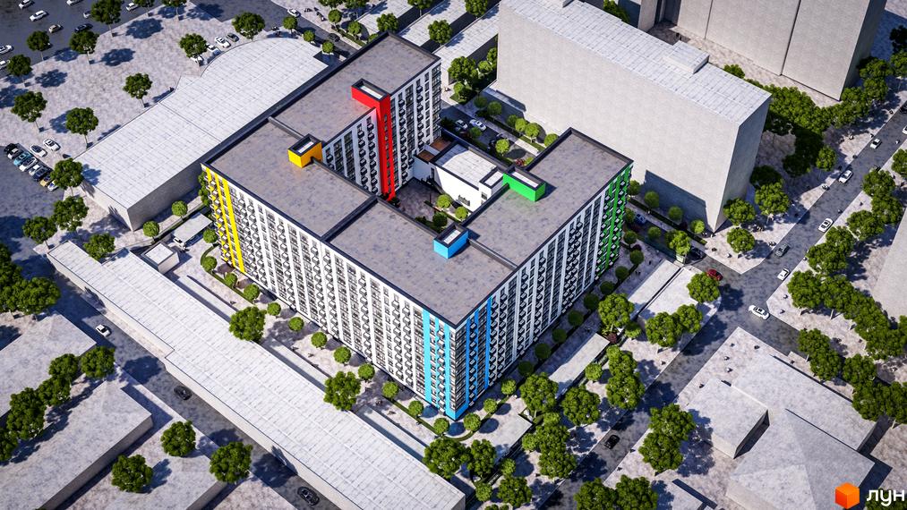 Зовнішній вигляд житлового комплексу BARVY з яскравими кольоровими акцентами на фасадах та зеленою прибудинковою територією. Комплекс має Г-подібну форму та розташований у міській забудові.