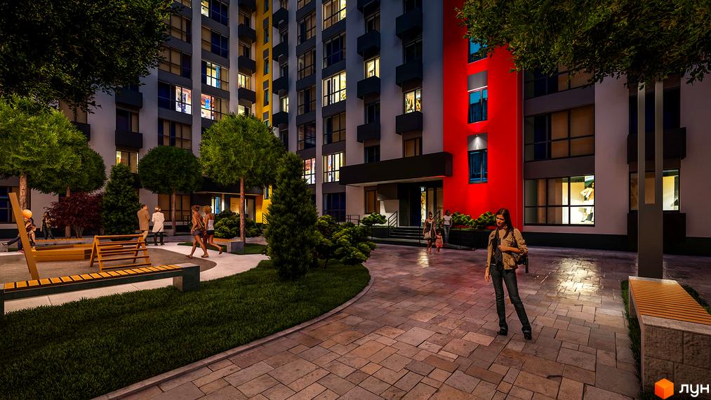 Житловий комплекс BARVY. Високоповерховий будинок з великими вікнами, яскравим фасадом та упорядкованою прибудинковою територією з лавками та зеленими насадженнями.