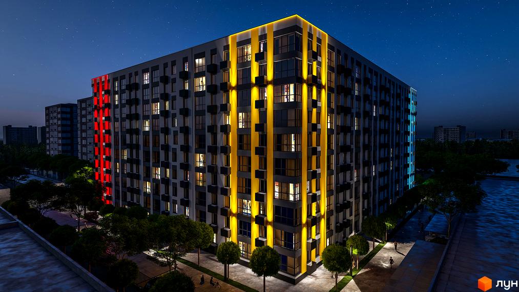 Висотна будівля ЖК BARVY з яскравою підсвіткою фасаду та вікнами, що світяться. На передньому плані зелені насадження та алея для прогулянок.