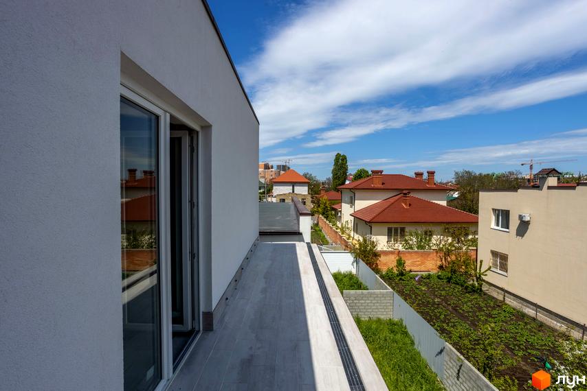 Вид з балкона на житловий комплекс на вул. Сергія Шелухина, 54. Будинки з червоними дахами та зелена прибудинкова територія.