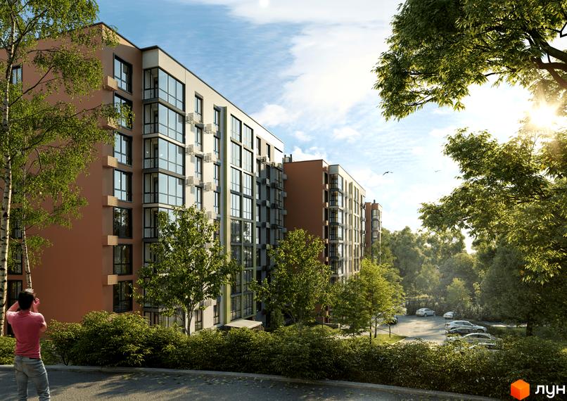 Житловий комплекс HARMONY for life з фасадами з панорамними вікнами та балконами, оточений зеленню та деревами. На прибудинковій території видно парковку з автомобілями.