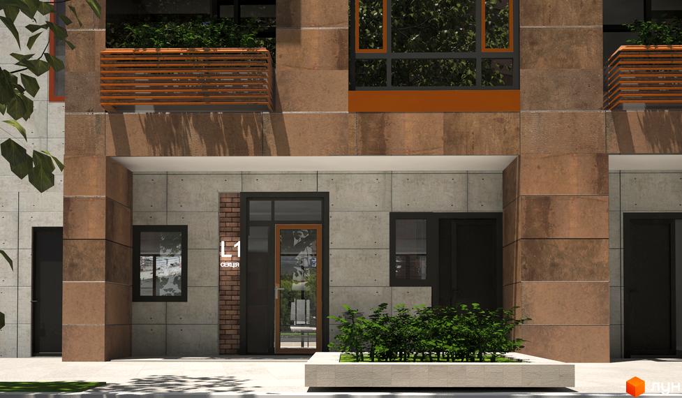 Фасад будівлі ЖК L-квартал з коричневим облицюванням та великими вікнами. Перед входом розташована зелена зона з кущами.