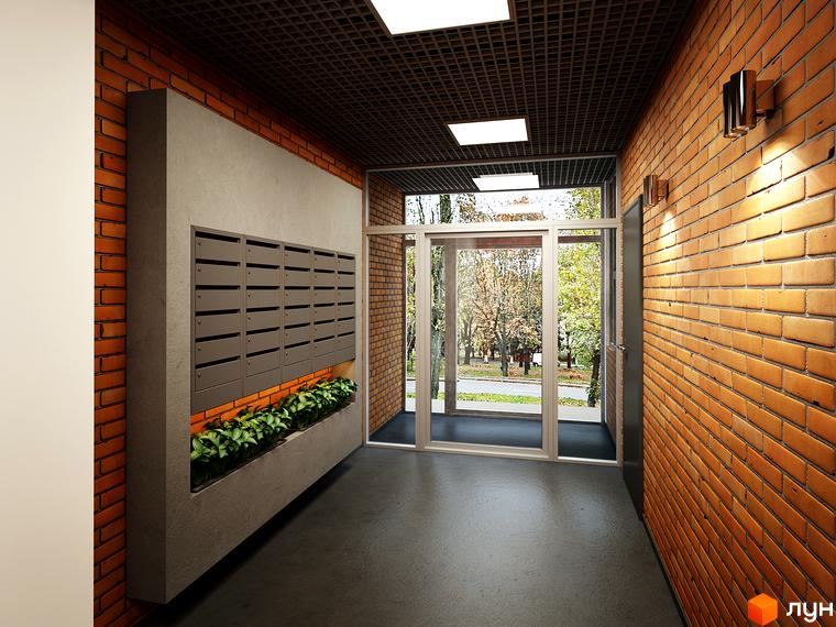 Коридор входу в будинок ЖК L-квартал з цегляними стінами та поштовими скриньками. Навпроти вхідні двері зі склом, за якими видно зелень.