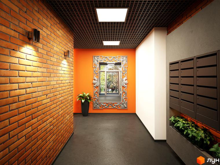 Коридор входу в ЖК L-квартал з цегляною стіною та дзеркалом. Темна підлога та поштові скриньки додають функціональності.