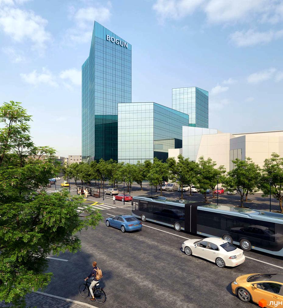Житловий комплекс Bogun з високими скляними будівлями та кутовим дахом. Навколо широка вулиця з автомобілями, автобусом та зеленими деревами.