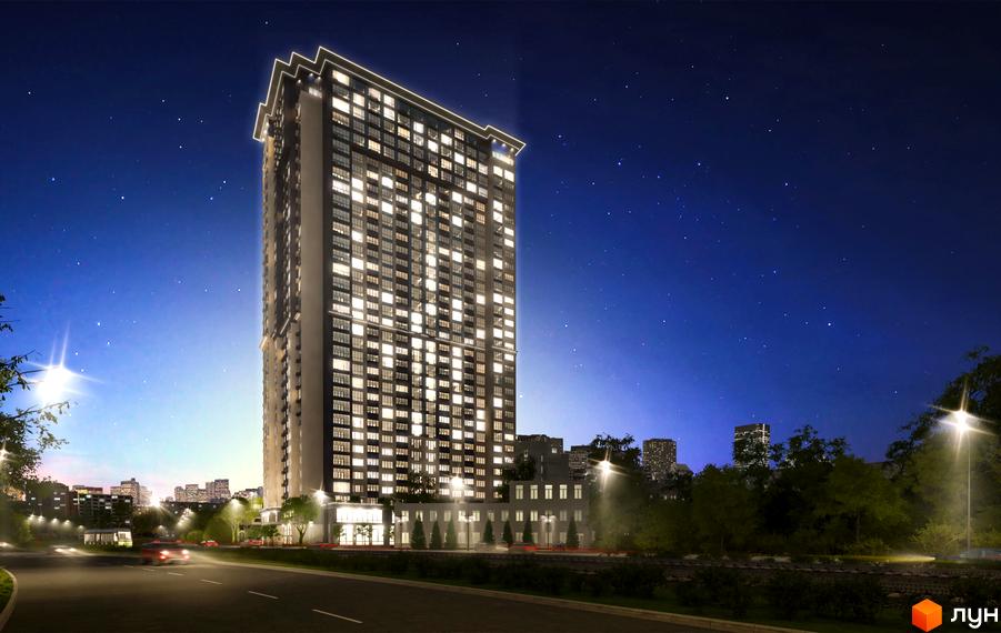 Житловий комплекс Victory V у вечірньому місті з підсвіченими вікнами. Навколо новобудови дорога з автомобілями та вуличним освітленням.