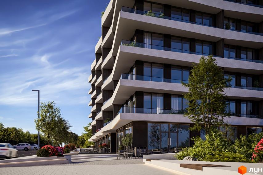 Зовнішній вигляд апарт-комплексу Primorsky Residence з терасами та панорамними вікнами. На території комплексу висаджено дерева та квіти, є місця для відпочинку.
