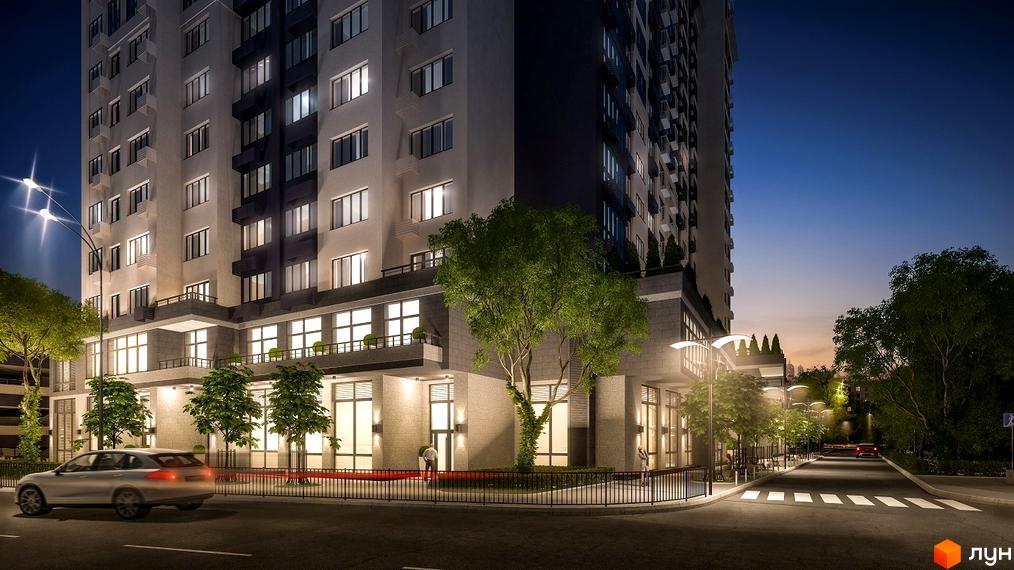 Житловий комплекс Victory V вночі. Сучасна архітектура будівлі з підсвіченими вікнами та фасадом. Прибудинкова територія з деревами та освітленням.