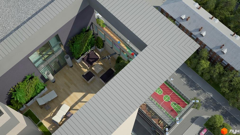 Вид зверху на житловий комплекс Victory V з внутрішнім двориком, зоною відпочинку та спортивним майданчиком. Навколо будинку зелені насадження та дорога.