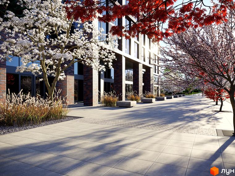 Зовнішній вигляд новобудови ЖК MARSHALL з цегляним фасадом та великими вікнами, оточеної квітучими деревами та зеленню.