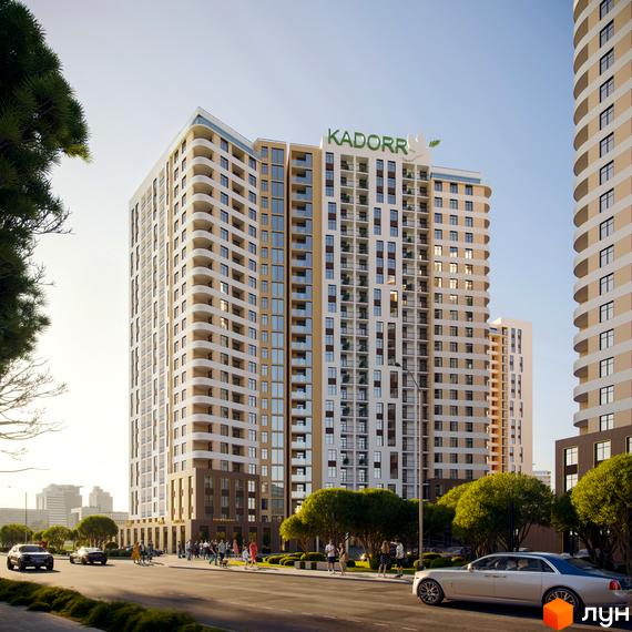 Житловий комплекс KADORR City з багатоповерховими будинками та балконами, розташований біля дороги з автомобілями та пішоходами.