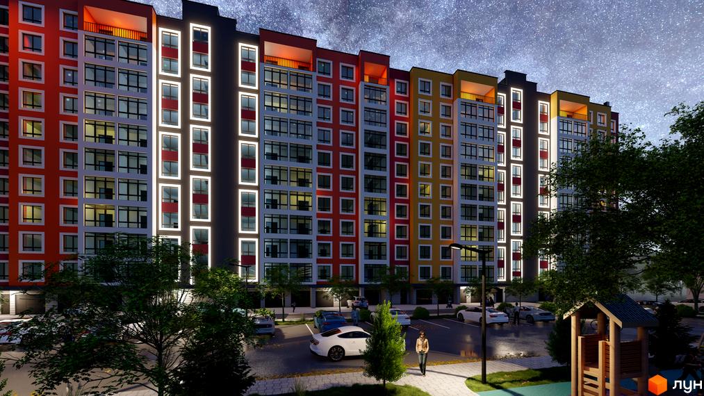 Житловий комплекс Янтарний з яскравим фасадом та підсвіткою вночі. На території розташовані парковка та дитячий майданчик.