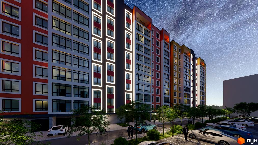 Житловий комплекс Янтарний. Багатоповерховий будинок з яскравим фасадом та підсвічуванням вікон на тлі зоряного неба. На прибудинковій території розташовані дерева та припарковані автомобілі.