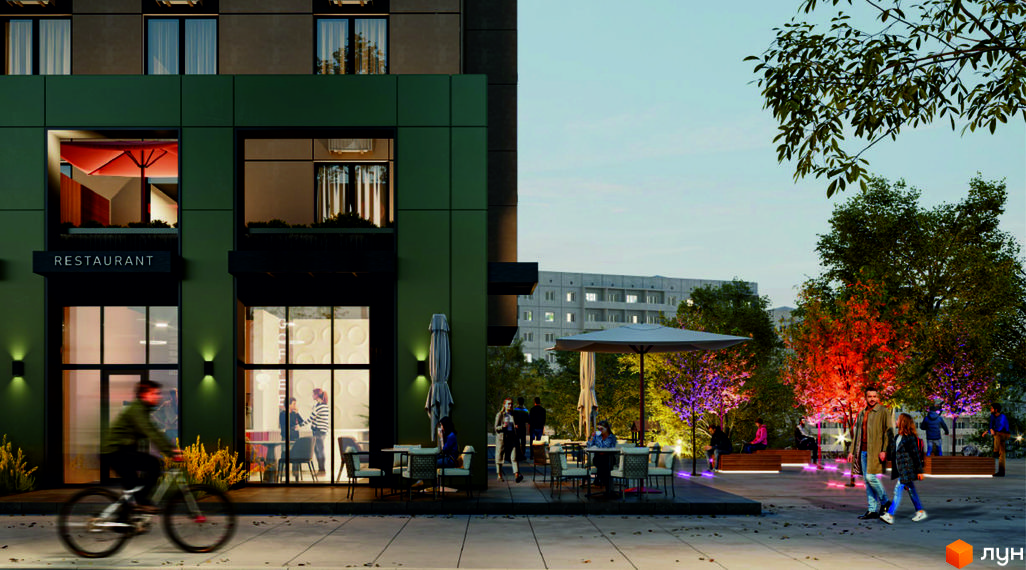Фасад Житлового комплексу M.Park у темних тонах з рестораном на першому поверсі. Прибудинкова територія з деревами, освітленням та зонами відпочинку.