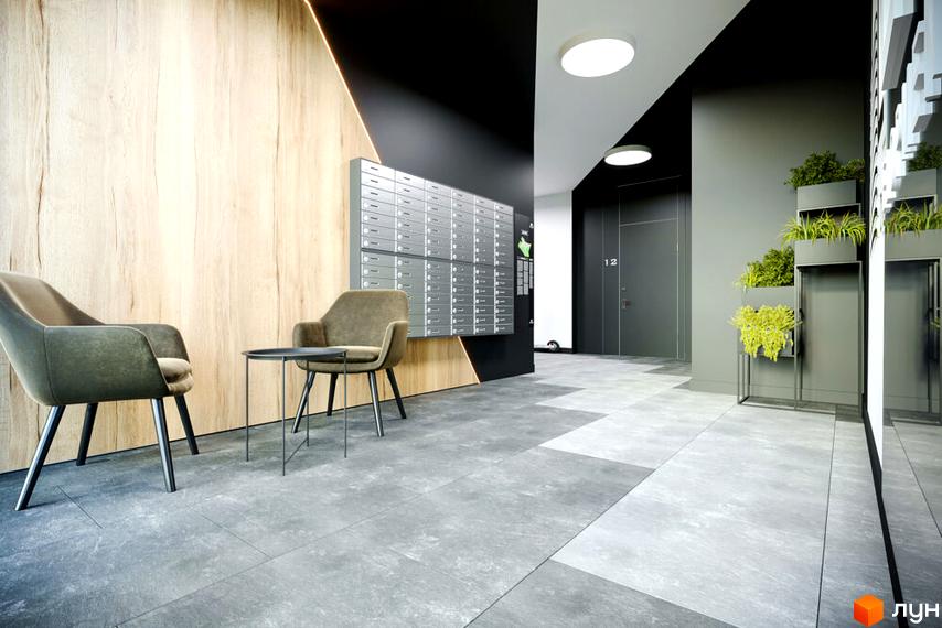 Дизайн холу житлового комплексу OBRIY3 з кріслами та поштовими скриньками. Сучасний інтер'єр з дерев'яними панелями та сірою плиткою на підлозі.