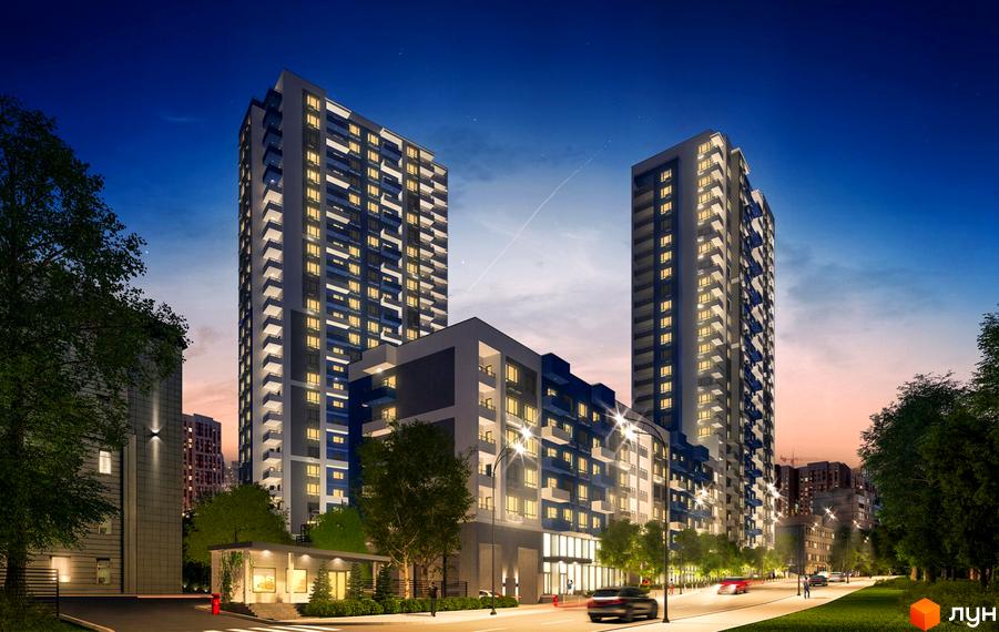 Житловий комплекс Воздухофлотський квартал. Сучасні висотні будинки з балконами та освітленими вікнами на тлі вечірнього неба. Навколо зелені насадження та дорога з автомобілями.