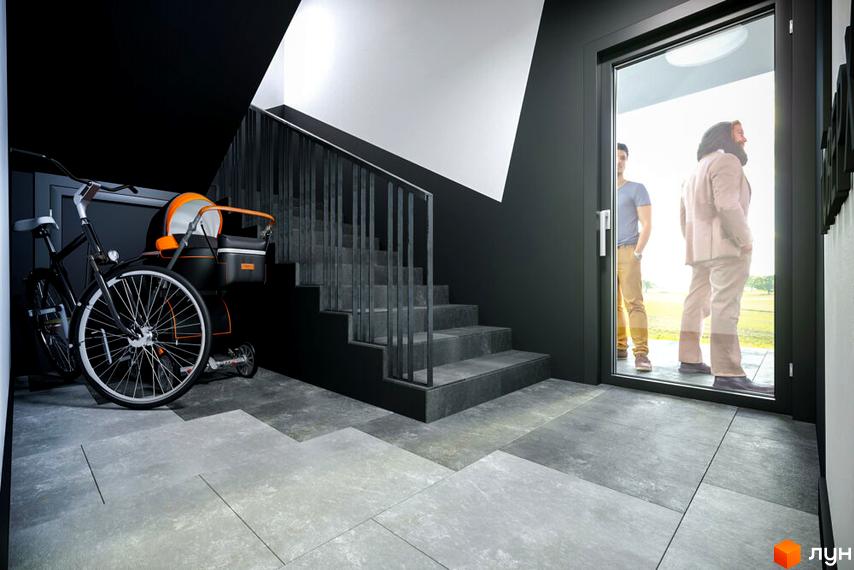 Сучасний вхід до житлового комплексу OBRIY3 з велосипедом та дитячим візком біля сходів. Зовні видно людей, що виходять назовні.