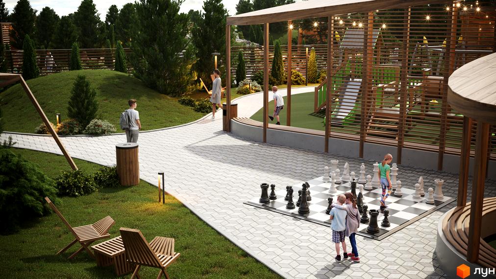 Котеджне містечко Затишний: дитячий майданчик з гойдалками та гірками, зона відпочинку з великими шахами та лавками.