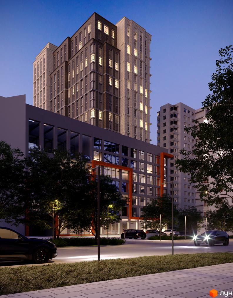 Багатоповерховий Житловий комплекс Premier Tower ввечері з підсвіченими вікнами, поруч освітлена прибудинкова територія та автомобілі.