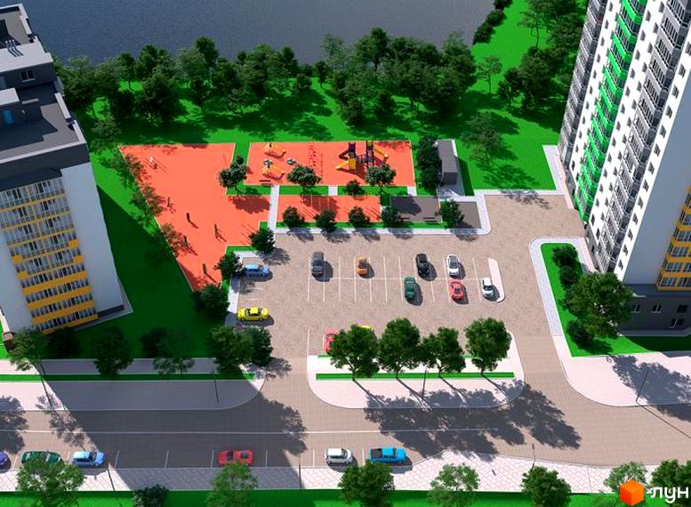 Житловий комплекс Гетьманський: вид згори на багатоповерховий будинок з жовтими вікнами та прибудинковою територією з дитячим майданчиком та парковкою.