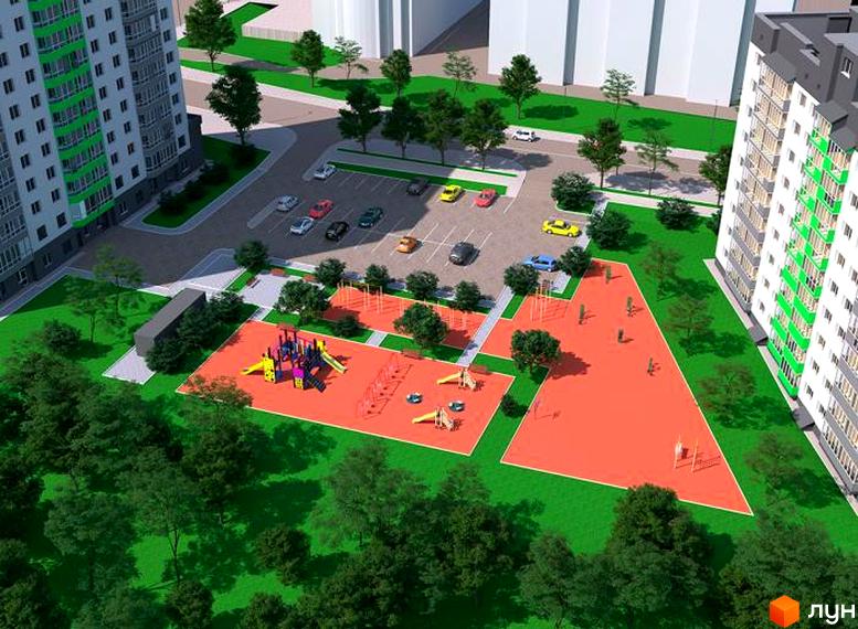 Житловий комплекс Гетьманський: вид згори на сучасні багатоповерхові будинки та облаштований дитячий майданчик з червоним покриттям.