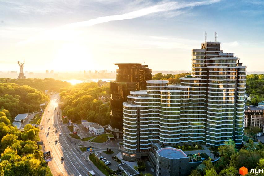 Житловий комплекс PecherSKY з сучасними будівлями та зеленими прибудинковими територіями. Вид на комплекс з висоти, оточений природою.