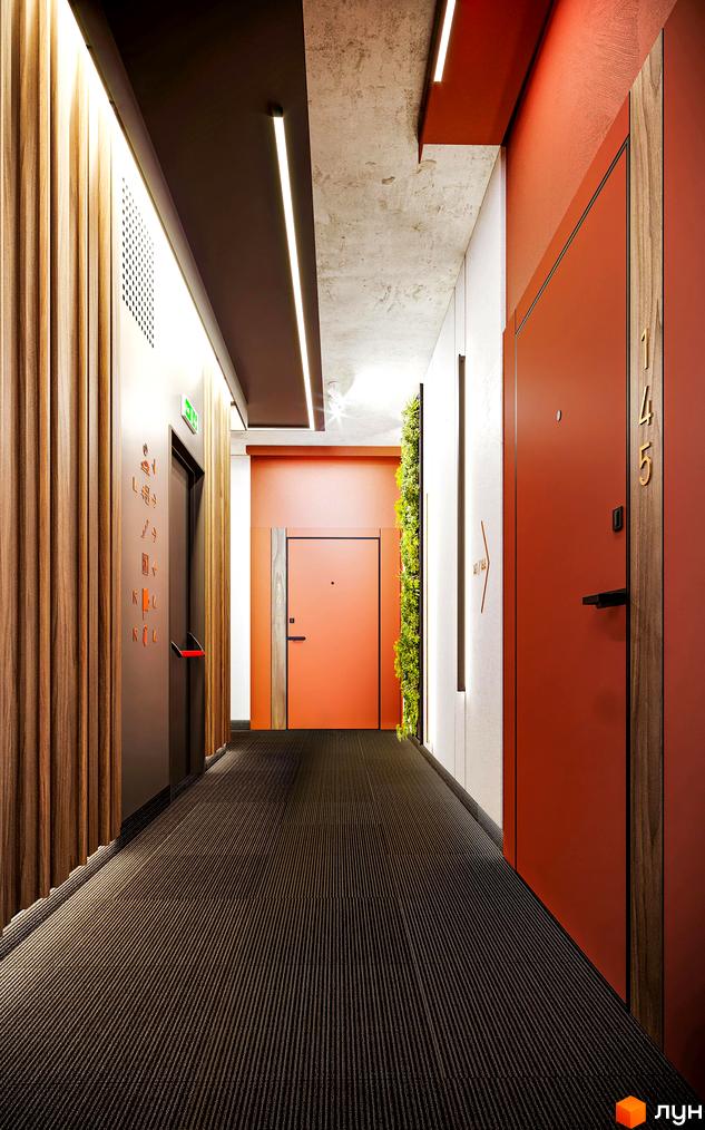 Інтер'єрний коридор у житловому комплексі Life Story: темний смугастий килим, помаранчеві двері, дерев'яні панелі та стіна з рослин.