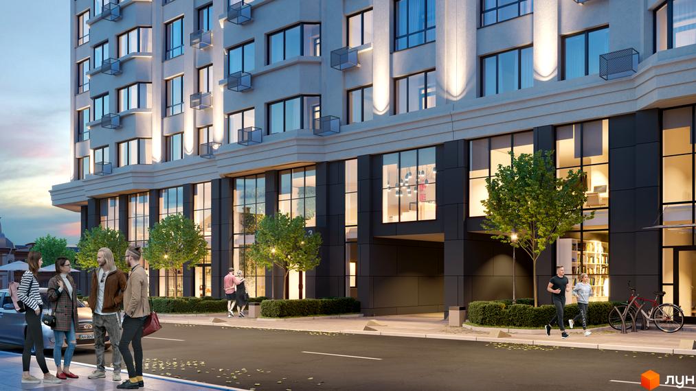 Житловий комплекс Дім на Подолі з фасадом з великими вікнами та освітленням. Навколо будинку зелені насадження та тротуар з людьми.