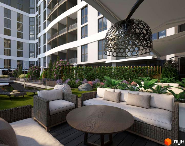 Зовнішній вигляд будинку ЖК GRAND HALL з зоною відпочинку: диванами, столиком та зеленою територією. Насолоджуйтесь комфортом та красою в новому житловому комплексі!