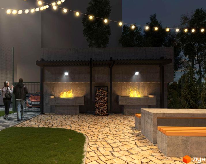 Житловий комплекс GRAND HALL: затишна зона відпочинку з мангалом та місцями для сидіння на бруківці.