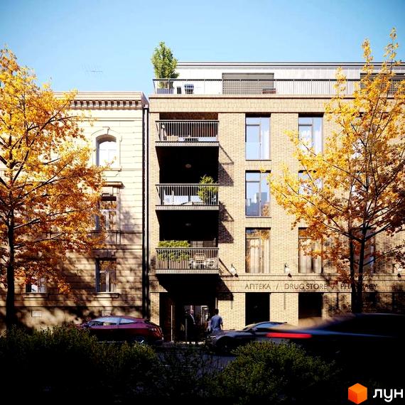 Житловий комплекс Княжий Холл: багатоповерховий цегляний будинок з балконами та великими вікнами, оточений осінніми деревами.