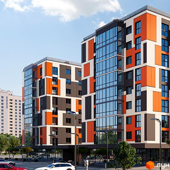 Новобудова Orange City з яскравими помаранчевими, сірими та білими фасадами. Поруч облаштована територія з деревами та парковкою.