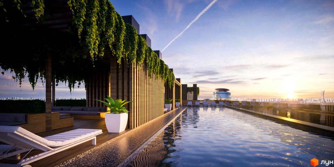 Басейн на даху житлового комплексу на вул. Болсуновська, 16, з лаунж зоною та шезлонгами. Навколо зелені насадження та вид на місто.