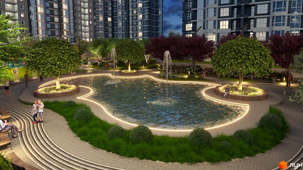 Високі житлові будинки Житлового комплексу Гранд Бурже з облаштованою прибудинковою територією, що включає водойму з підсвічуванням та фонтанами, зелені насадження та доріжки.