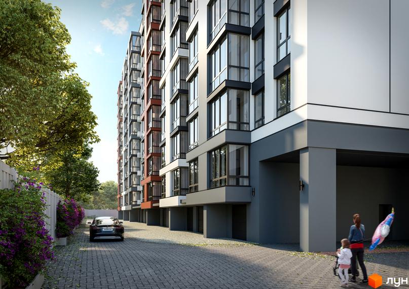 Багатоповерховий будинок Житлового комплексу Молодіжний з комбінованим фасадом. На брукованій території є зелені насадження та авто.