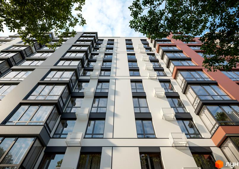 Житловий комплекс Молодіжний з біло-сіро-теракотовими фасадами, великими вікнами та кошиками для кондиціонерів на тлі неба і дерев.