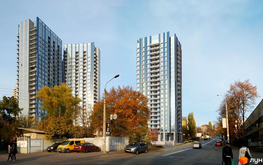 Житловий комплекс Central Park з двома висотними будинками, оточеними зеленими насадженнями та автомобільною дорогою.