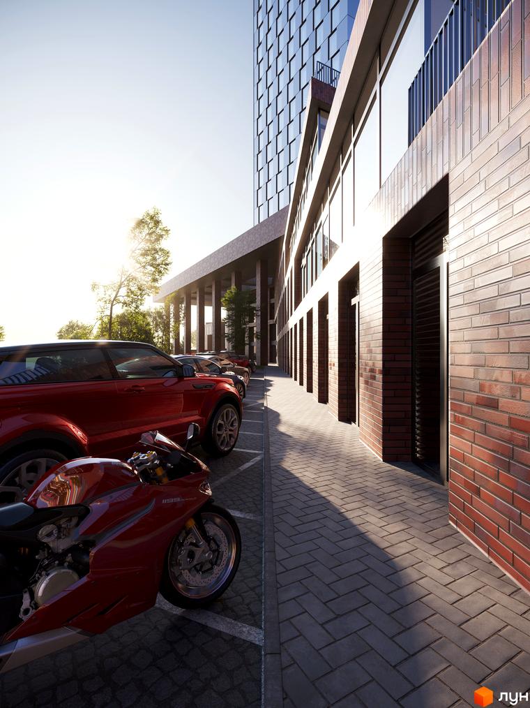 БФК MAYAK: сучасний житловий комплекс з червоної цегли та скла, парковка з червоними автомобілями та мотоциклом.